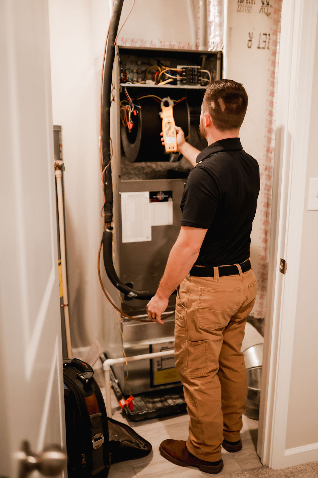 Tech Checking Voltage